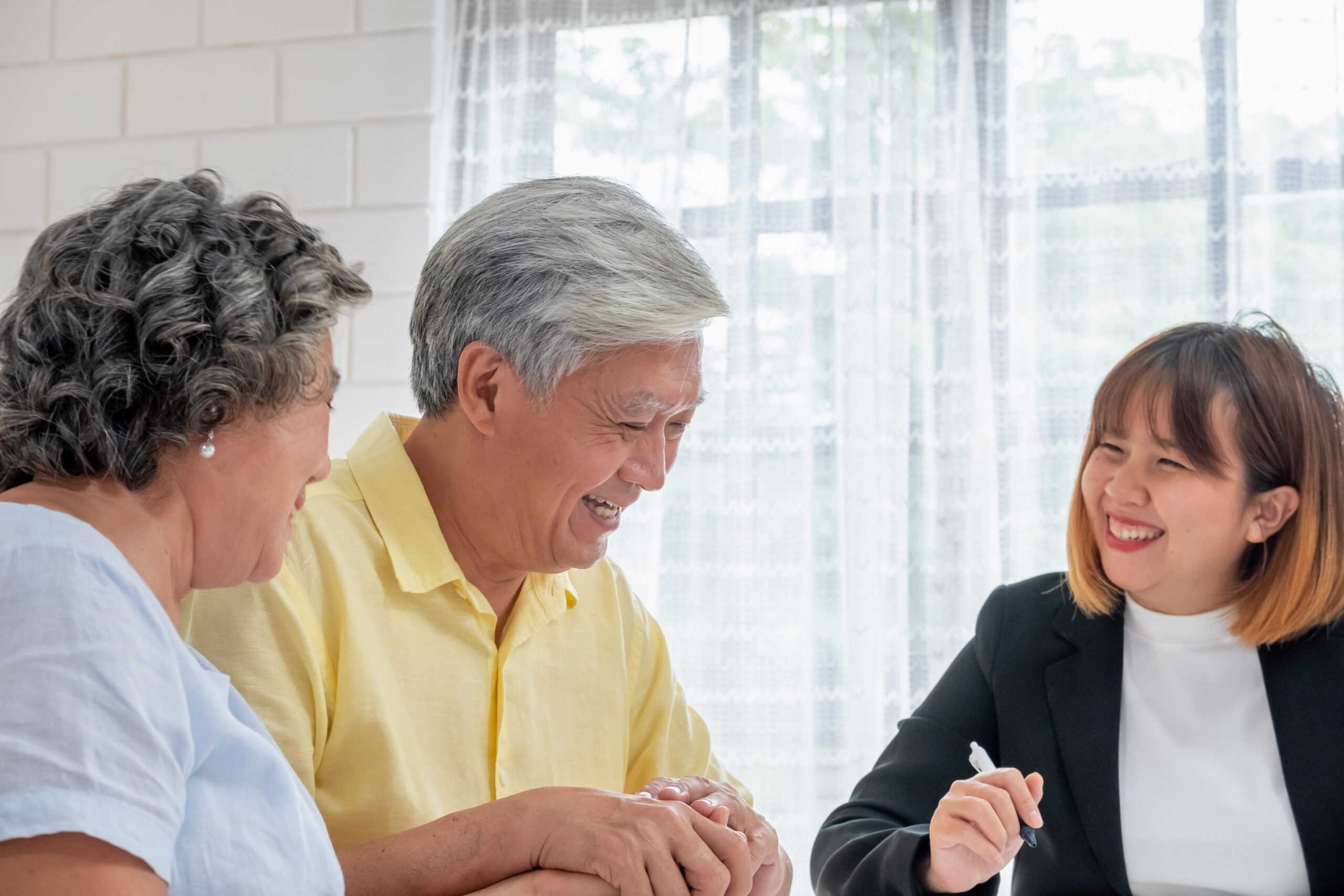 Asian senior couple with financial advisor about tax and retirem